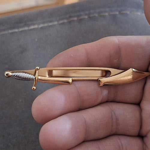 Gold pirate sword tie clip bar with ribbed dagger handle and pointed tip