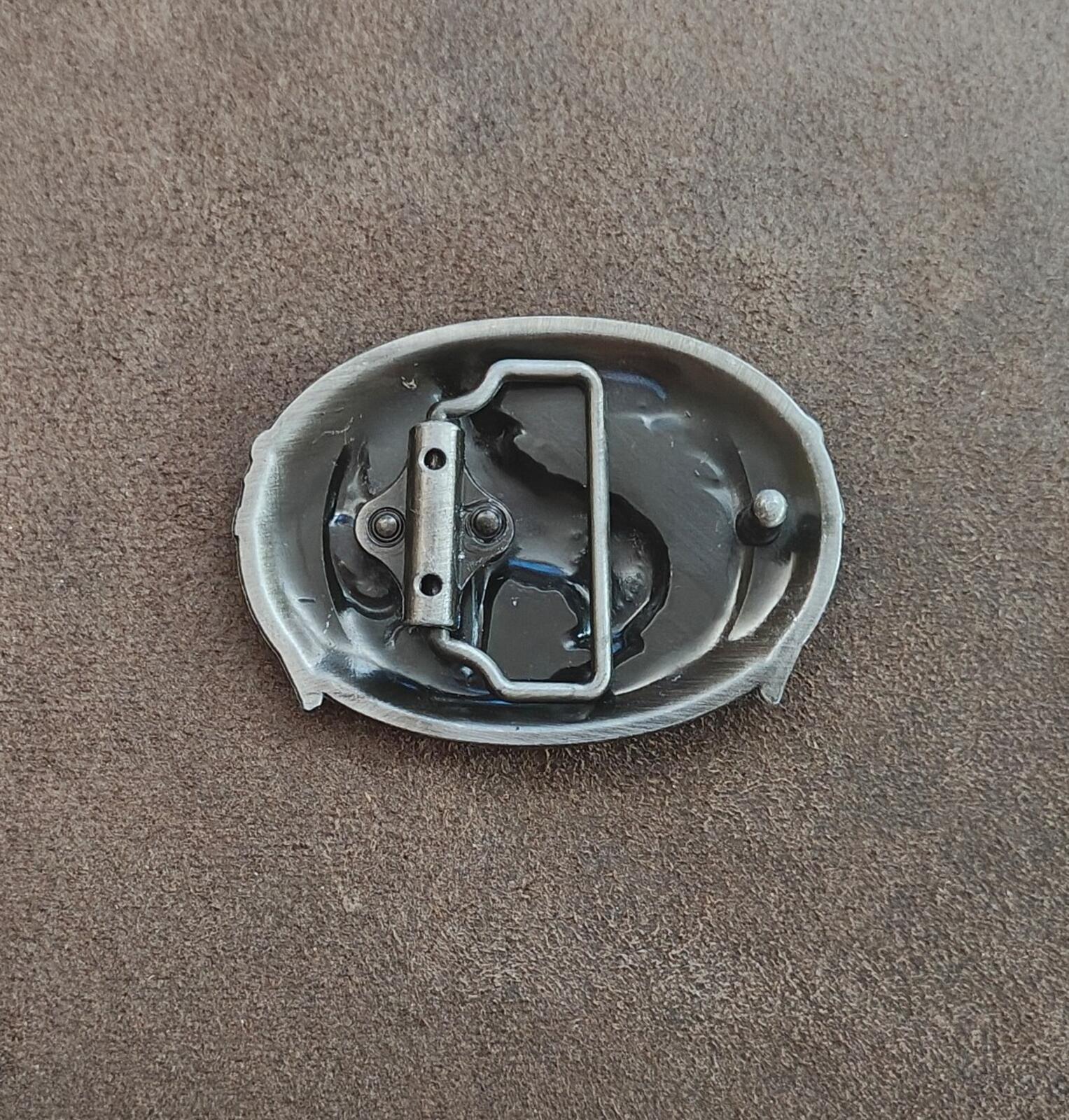 Back of a pewter belt buckle with metal loop bar and mounting hardware