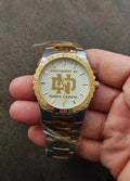 Gold and silver sports watch with white dial and University of North Dakota logo