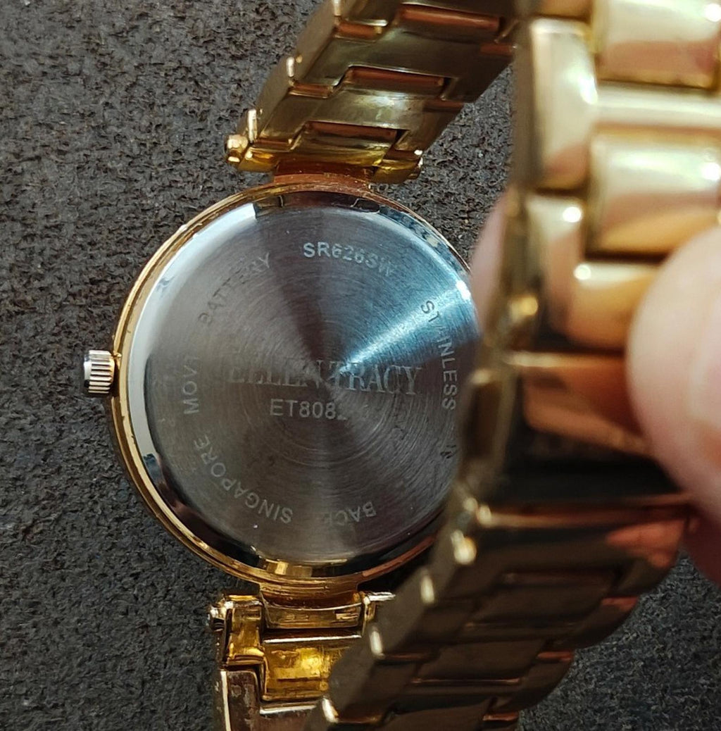 Gold watch caseback with Ellen Tracy and model marking text