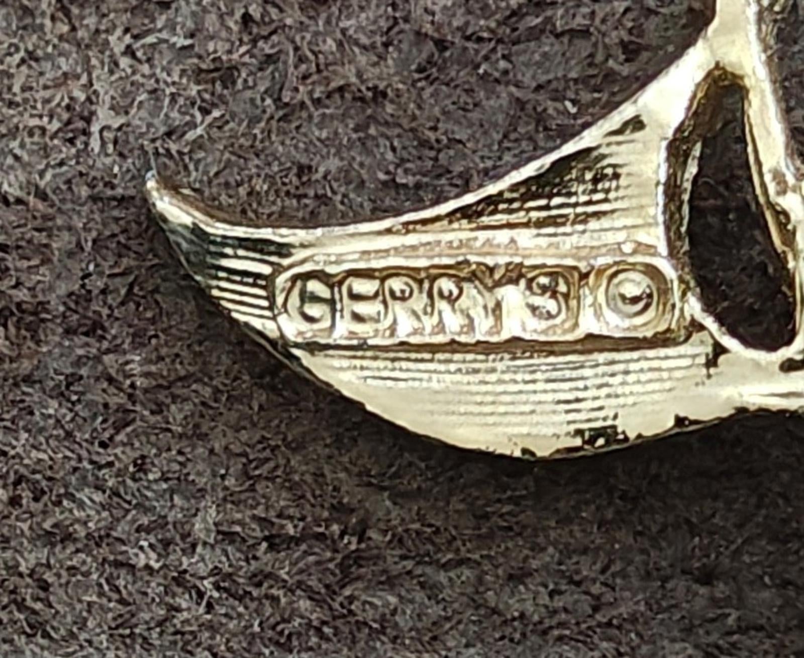 Engraved gold-tone golf pin wing with 'Gerry's' text and enamel trim