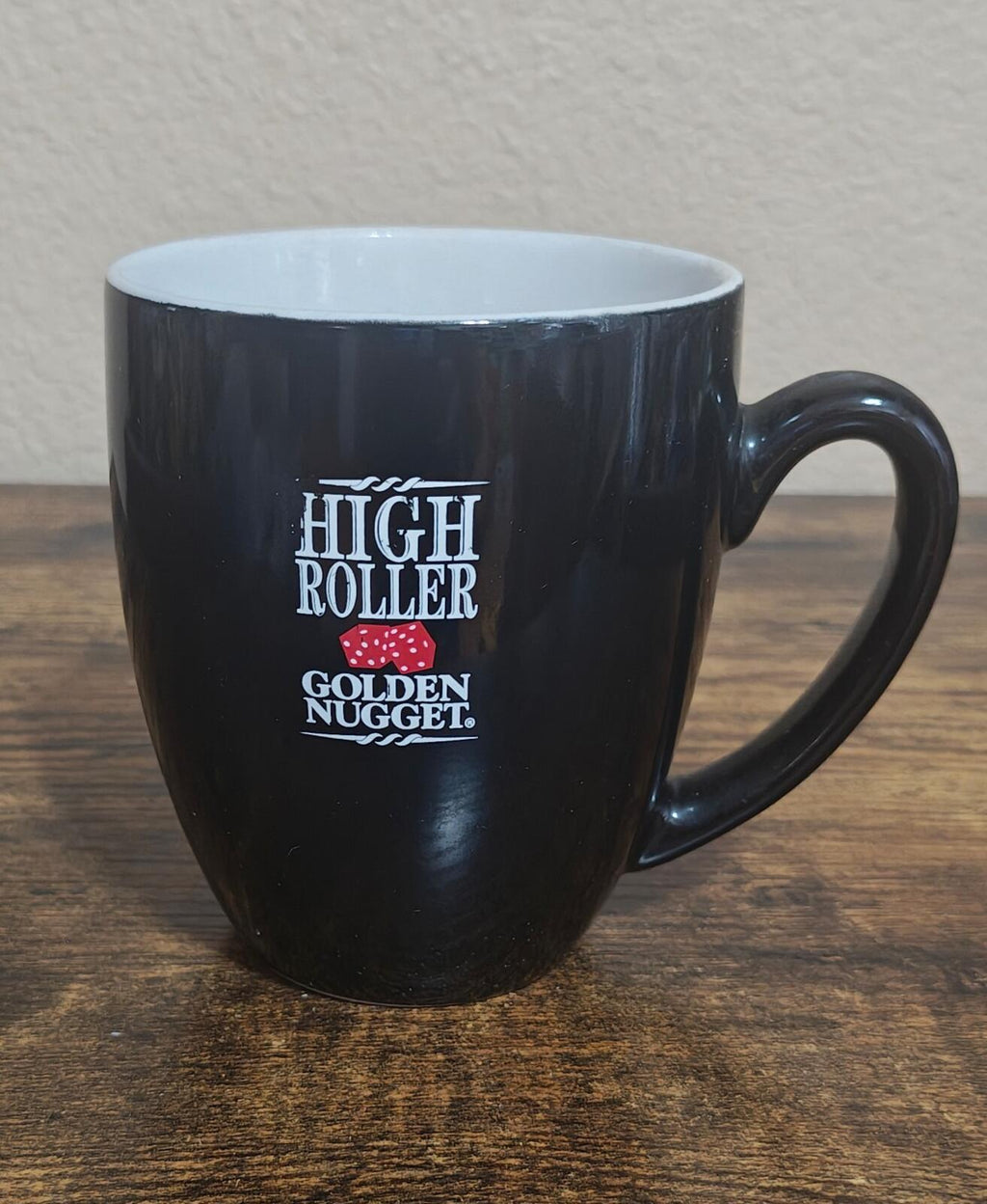 Black mug with High Roller and Golden Nugget logo, full front view