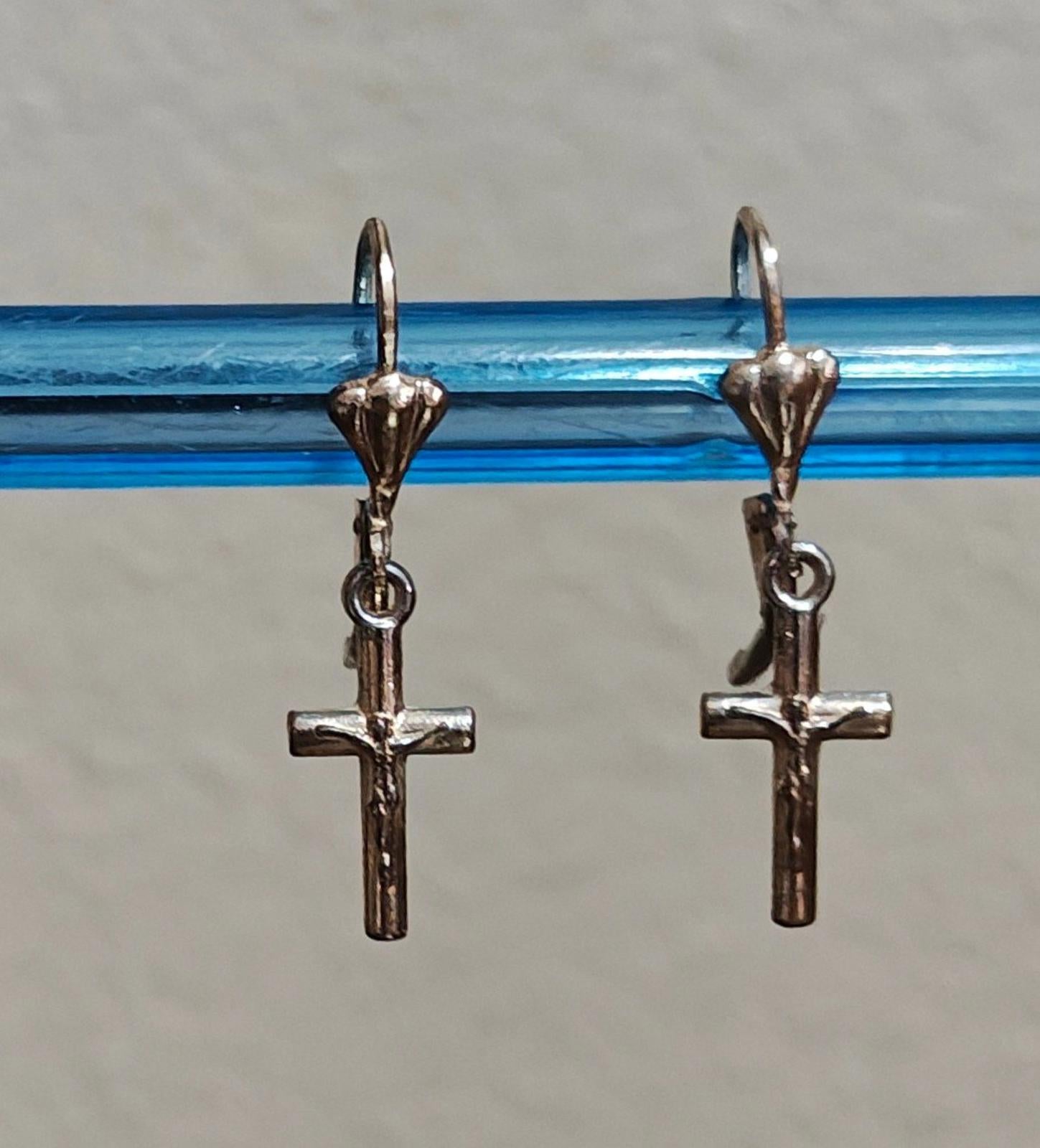 Silver-tone cross dangle earrings with heart charm tops and hook backs.