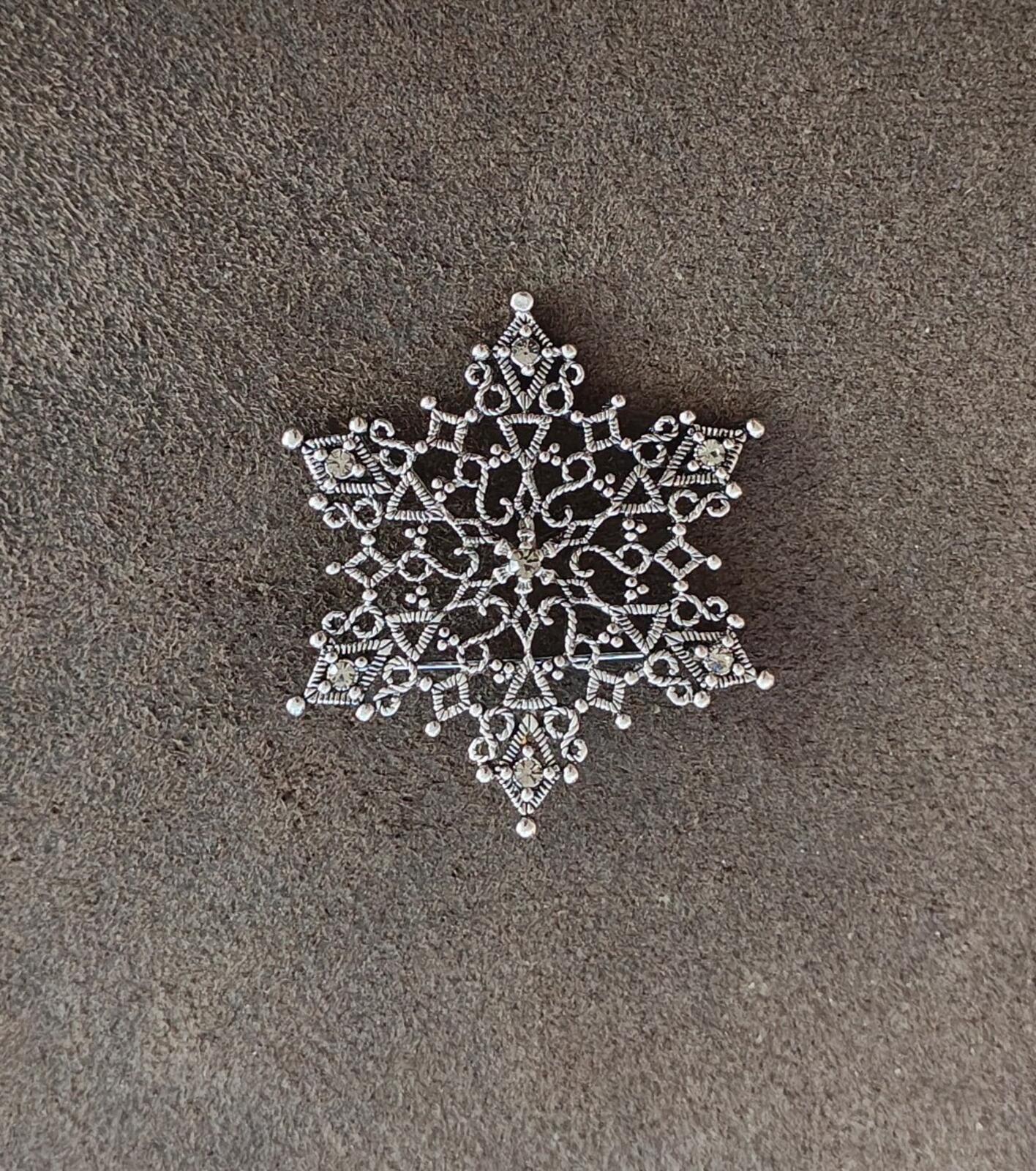 1990s Silver Tone Filigree Snowflake With Clear Rhinestone Accents Brooch.