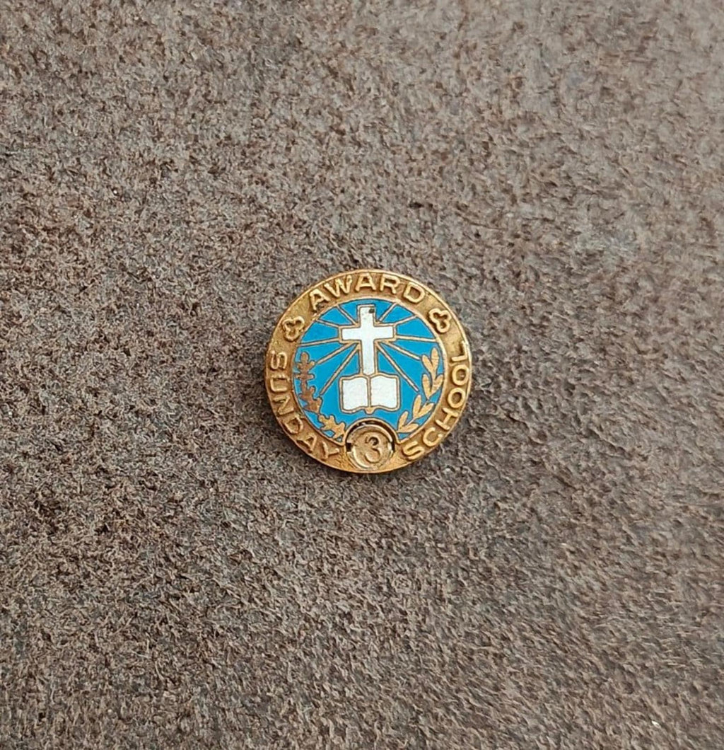 Gold-tone vintage award pin with blue enamel center cross and small "3" medallion