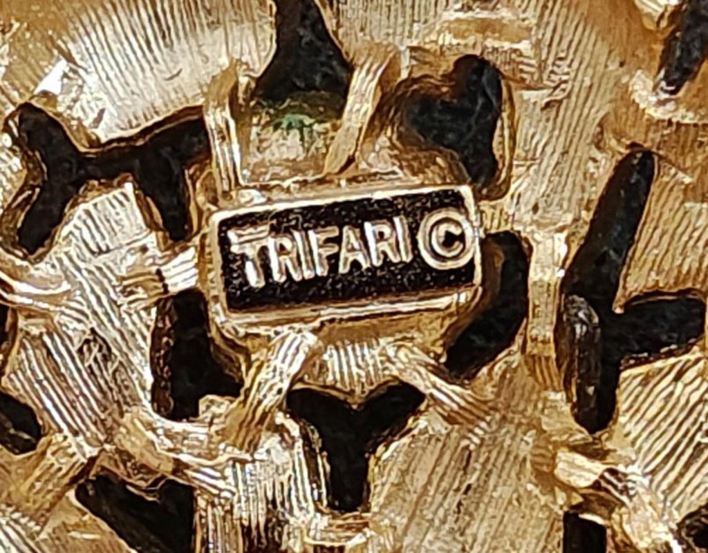 Close-up of TRIFARI hallmark on gold-tone textured wreath brooch