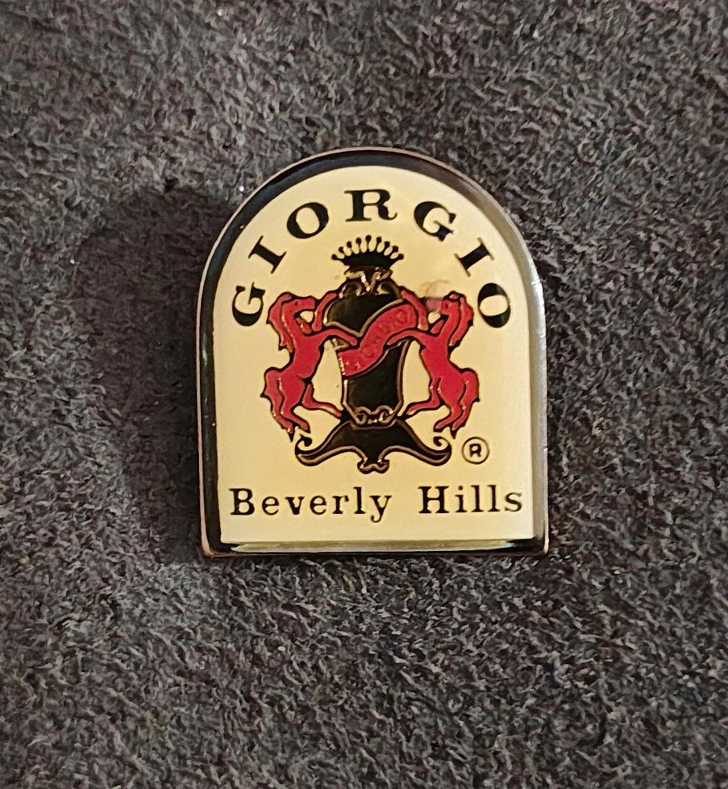 Gold-tone enamel crest pin with red lion, black shield details, and "Beverly Hills"