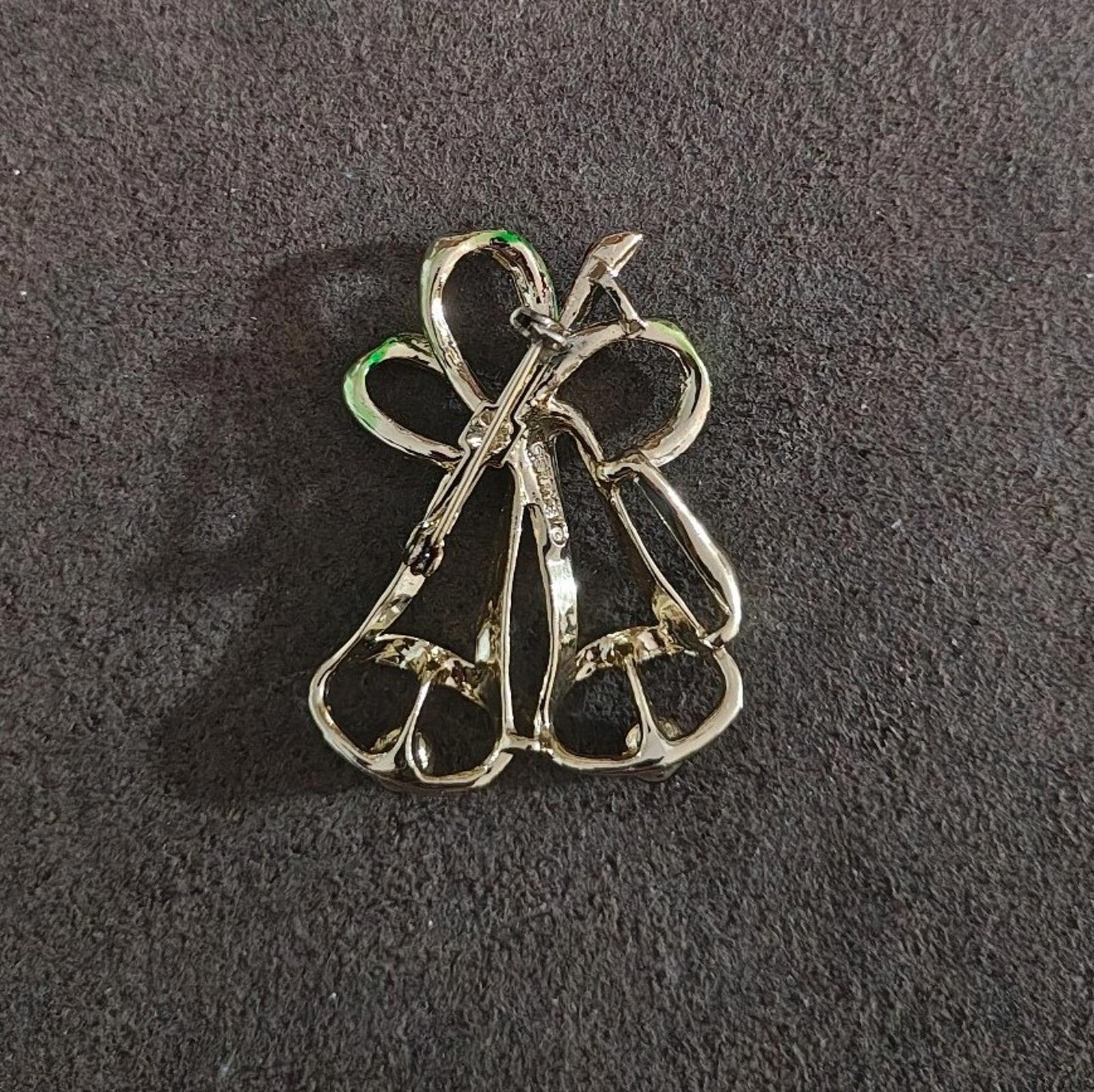 Gold-tone Christmas bells brooch pin back view with safety clasp and straight post
