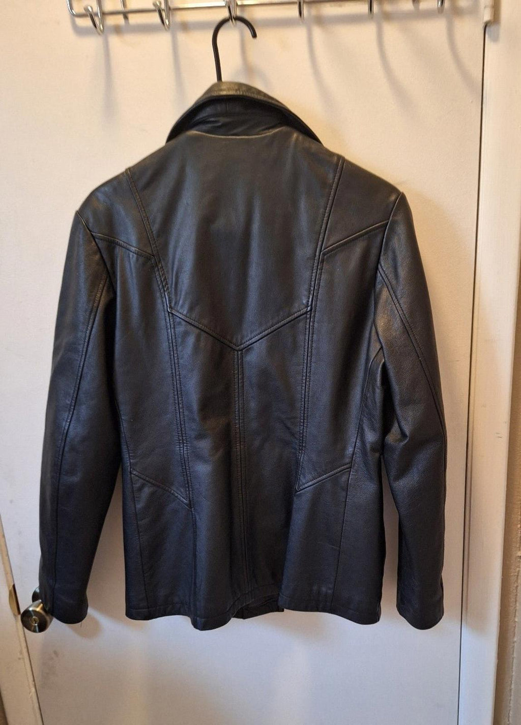 Women's Wilson's Maxima black leather jacket, back view with seam panels and yoke