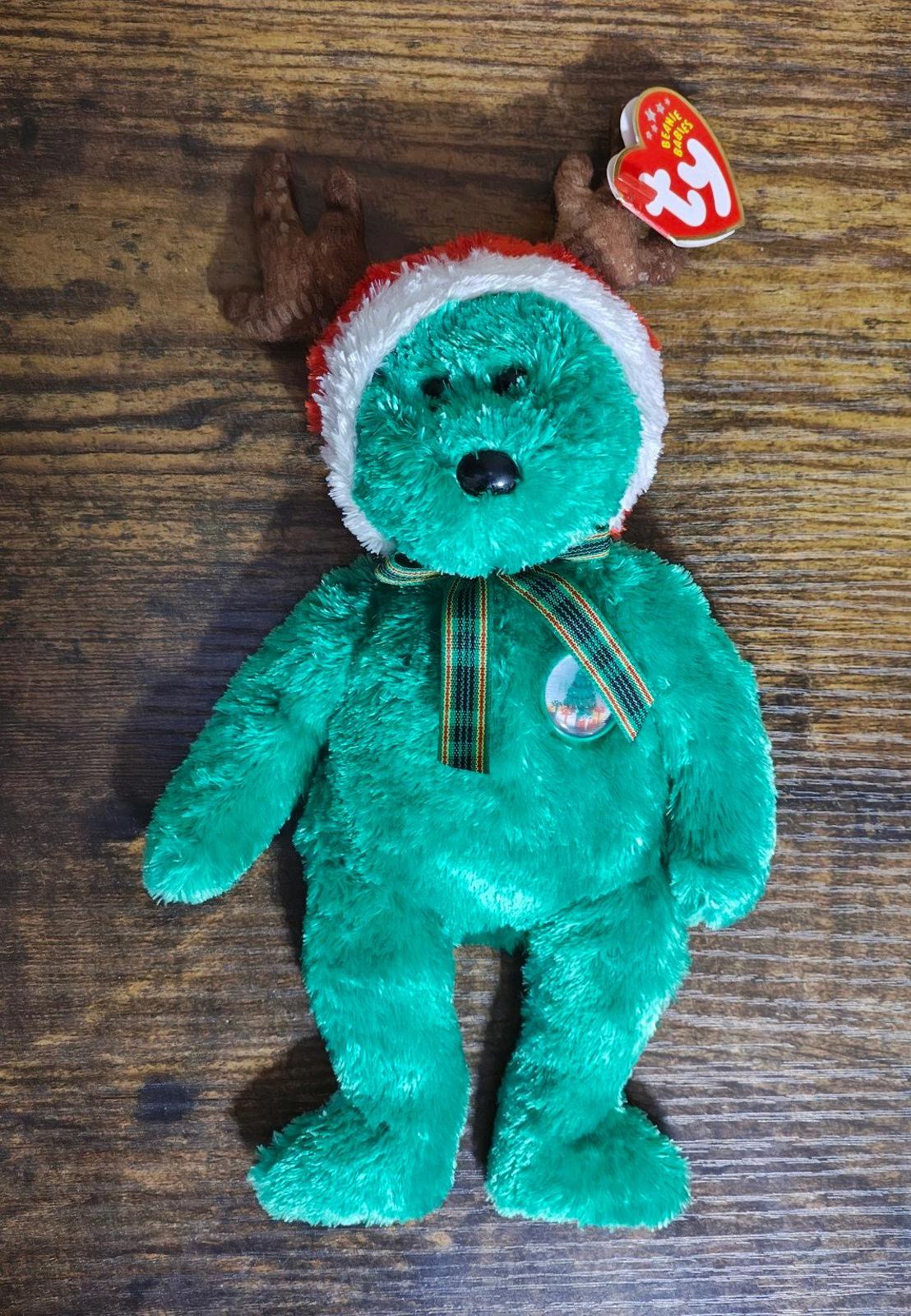 Green plush reindeer teddy bear standing with antlers and TY hang tag