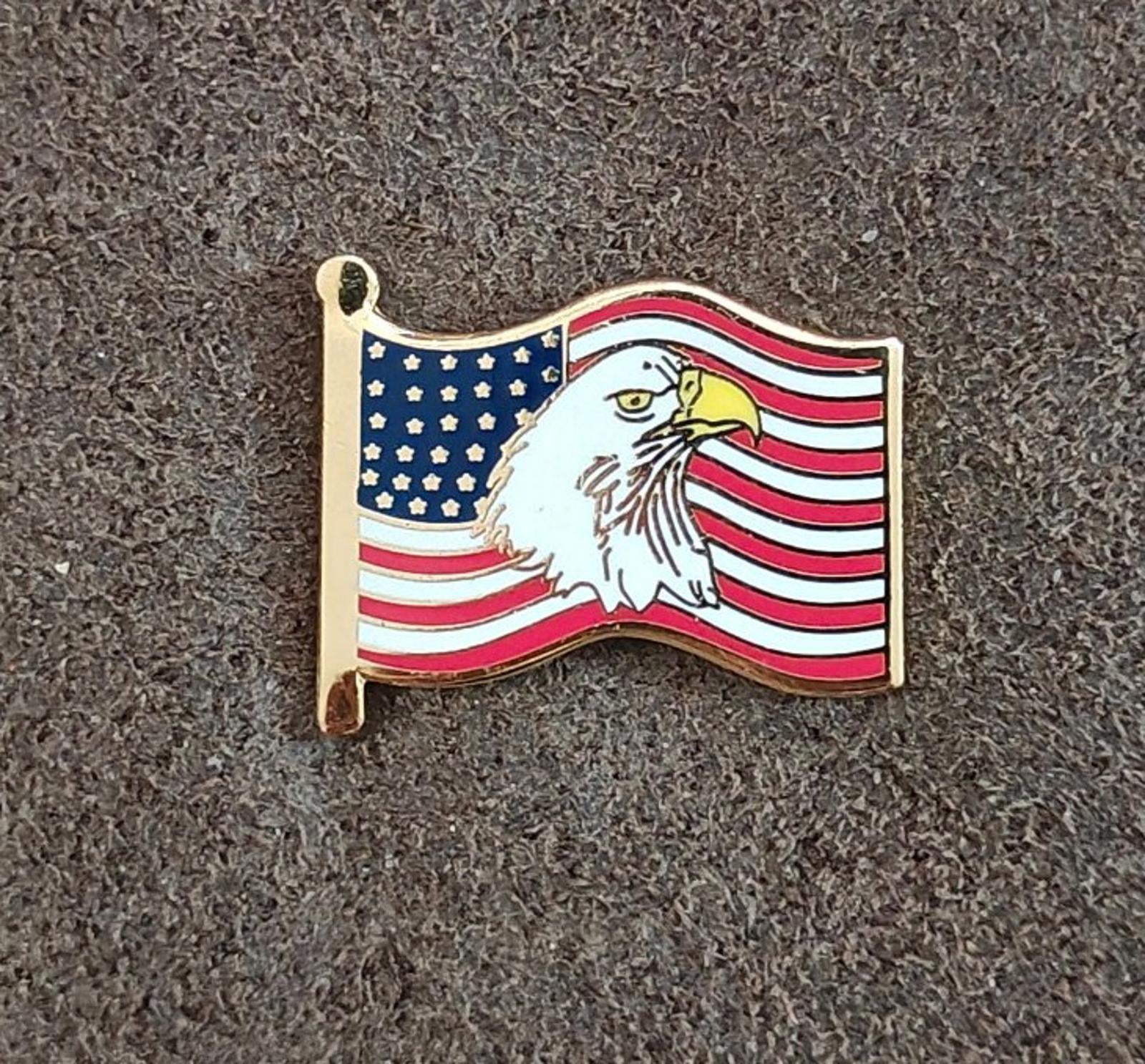 Gold-tone enamel wavy American flag lapel pin with bald eagle, front view