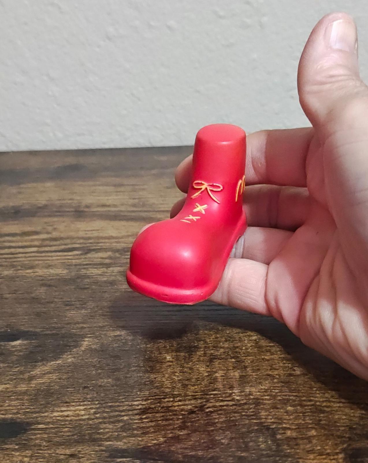 Red boot-style antenna topper figurine with gold McDonald's logo and ribbon detail
