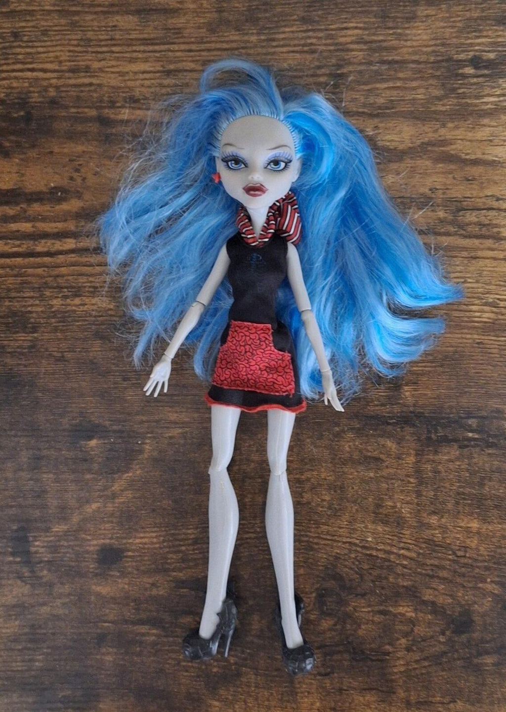Monster doll full body standing pose with long light-blue hair, black dress and red skirt