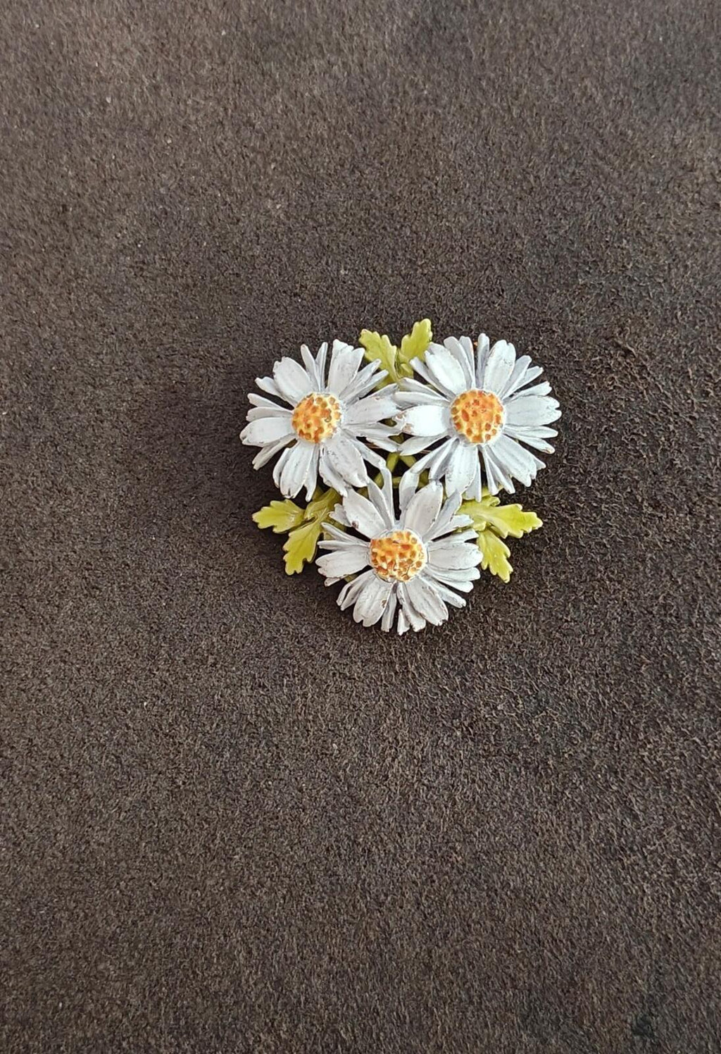 White enamel daisy cluster brooch with green enamel accents and gold-tone centers