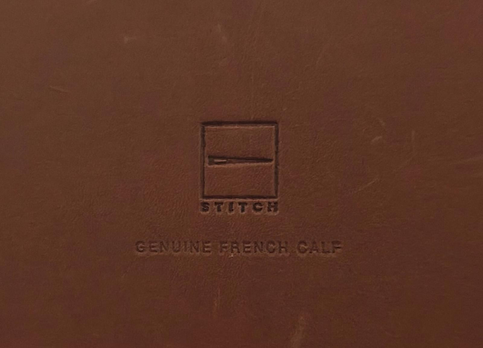 Brown leather album cover close-up with embossed logo and text