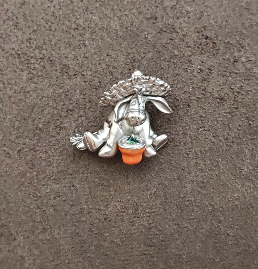Eeyore pewter enamel pin front view with orange base and green enamel bowl