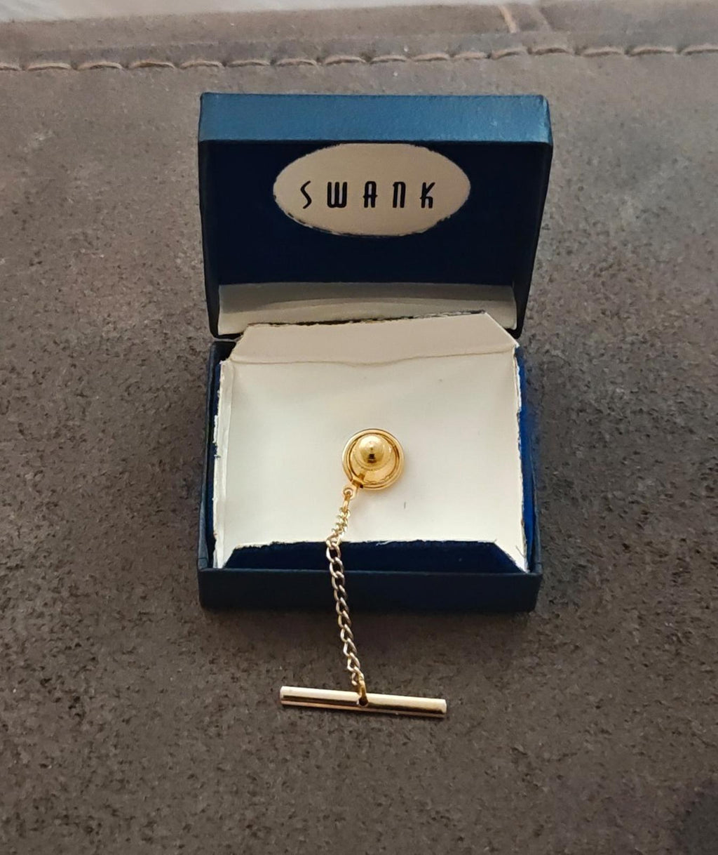 Gold-tone tie tack chain and globe topper in opened blue gift box