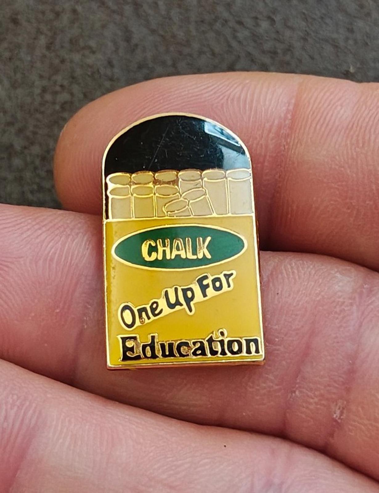 Gold-tone enamel teacher pin with chalkboard and “CHALK / One Up For Education”