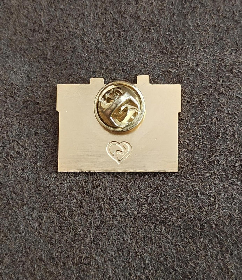 Back of gold enamel pin with locking clasp and small heart detail