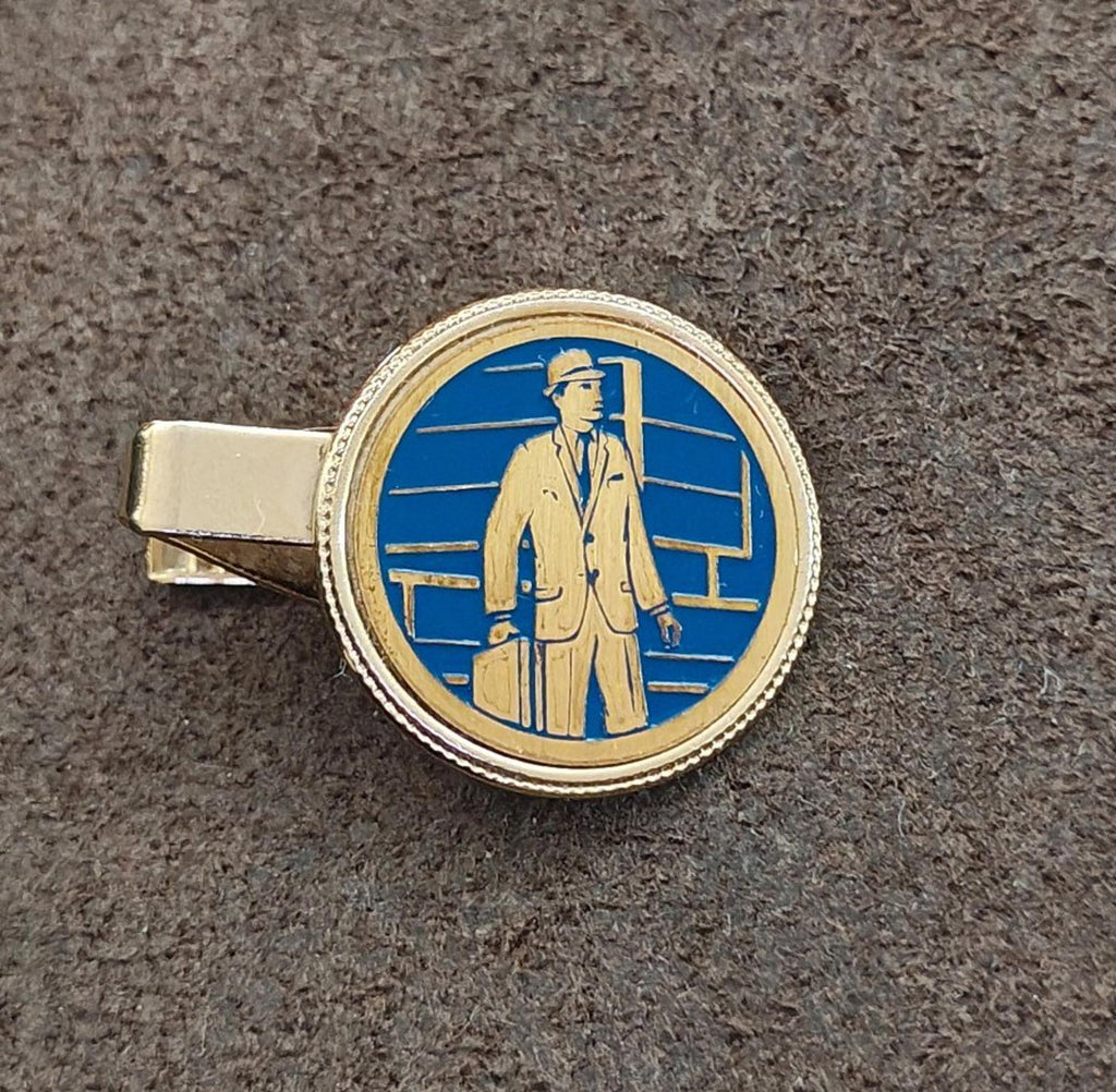 Gold-tone tie clip with round blue enamel cameo of a suited man