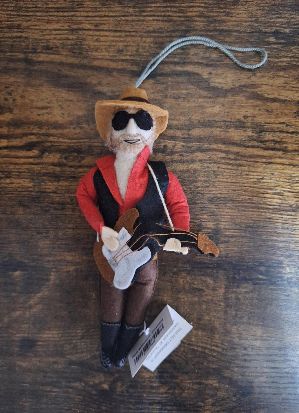 Felt and wool musician ornament with red jacket, black vest, sunglasses, and guitar