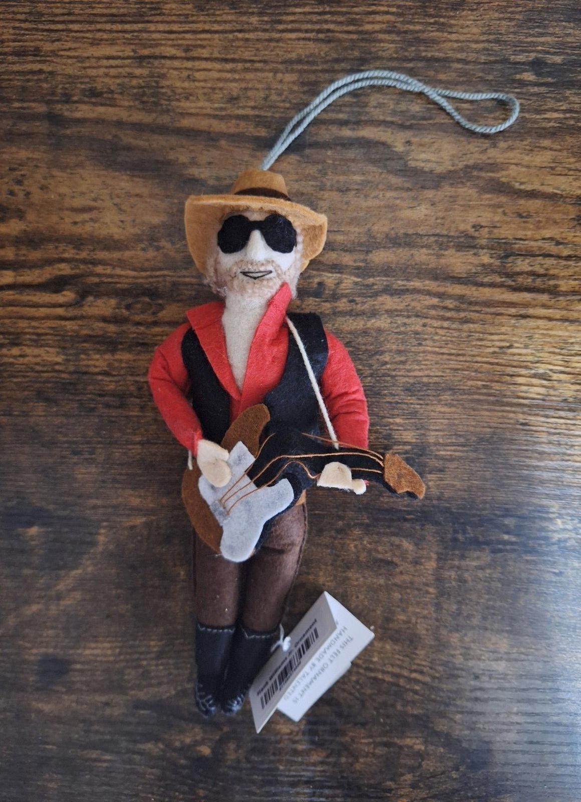 Felt and wool musician ornament with red jacket, black vest, sunglasses, and guitar