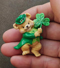 Green leprechaun bear brooch holding a green shamrock