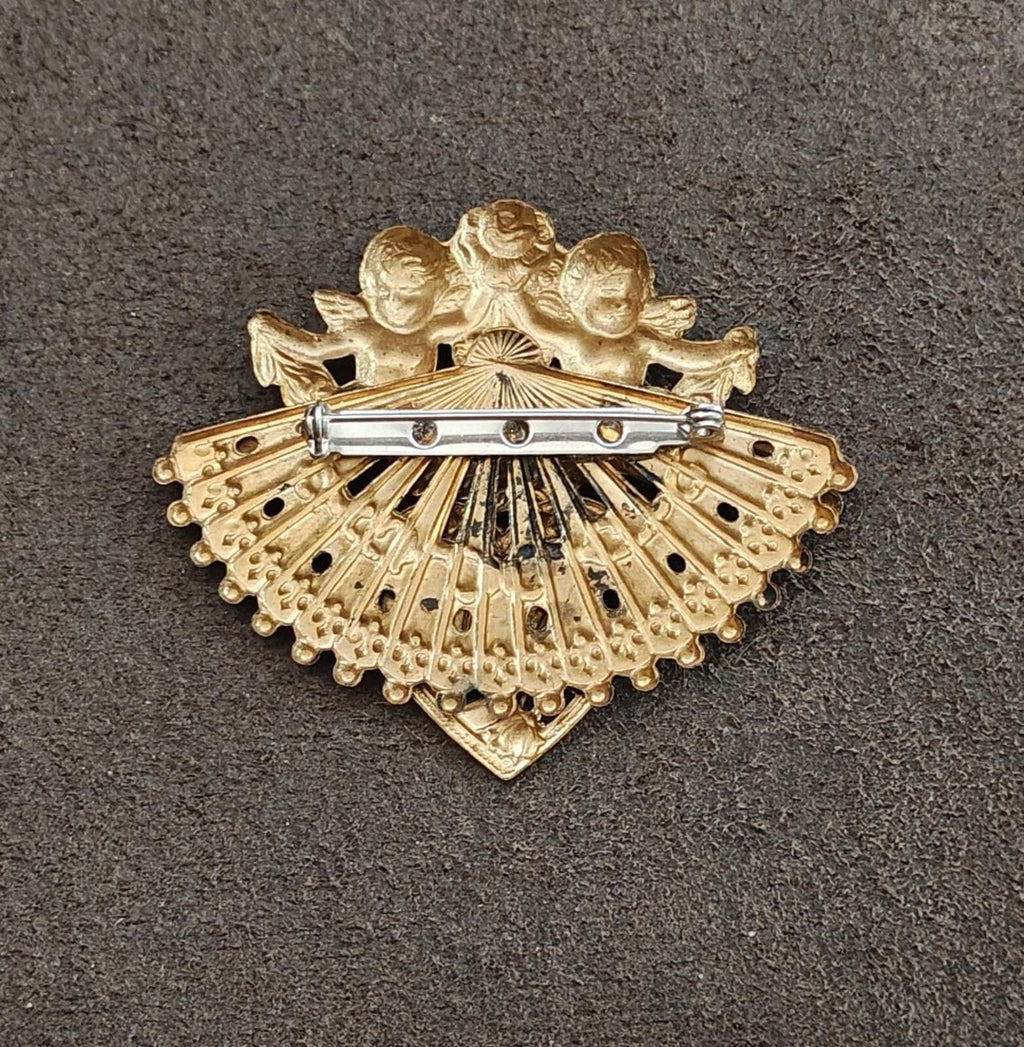 Gold-tone brooch back with bar clasp, fan-shaped cherub design and filigree