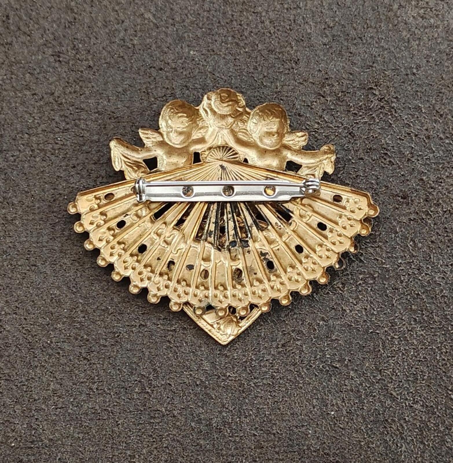 Gold-tone brooch back with bar clasp, fan-shaped cherub design and filigree