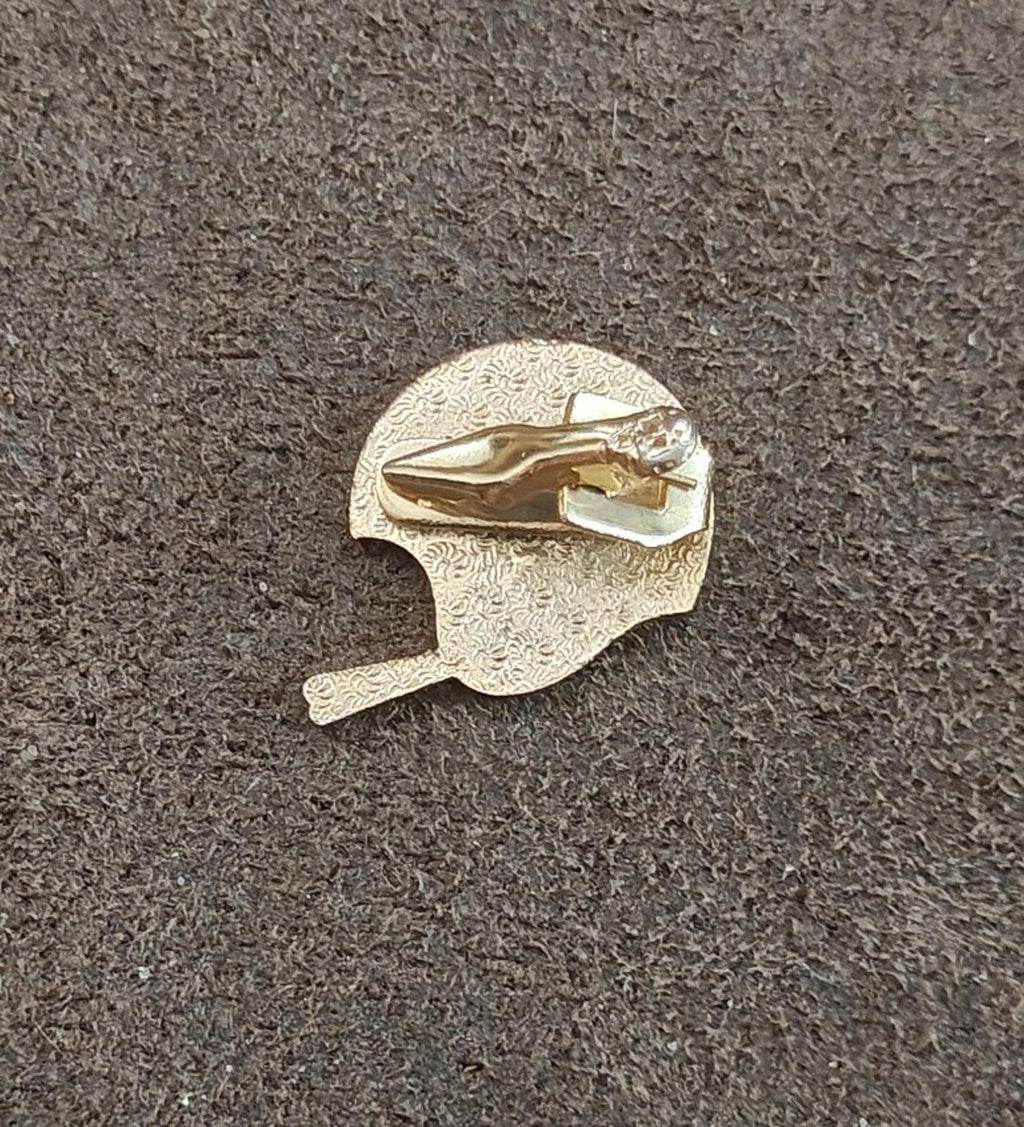 Gold-tone enamel tie clip back view with textured round gold plate