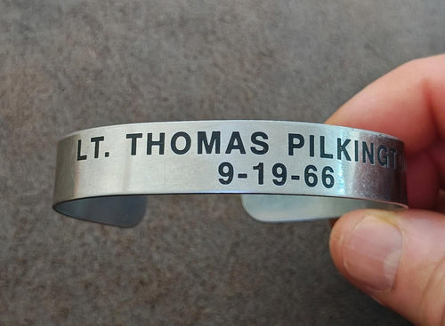 Silver tone cuff bracelet engraved "LT. THOMAS PILKINGTON" and date 9-19-66