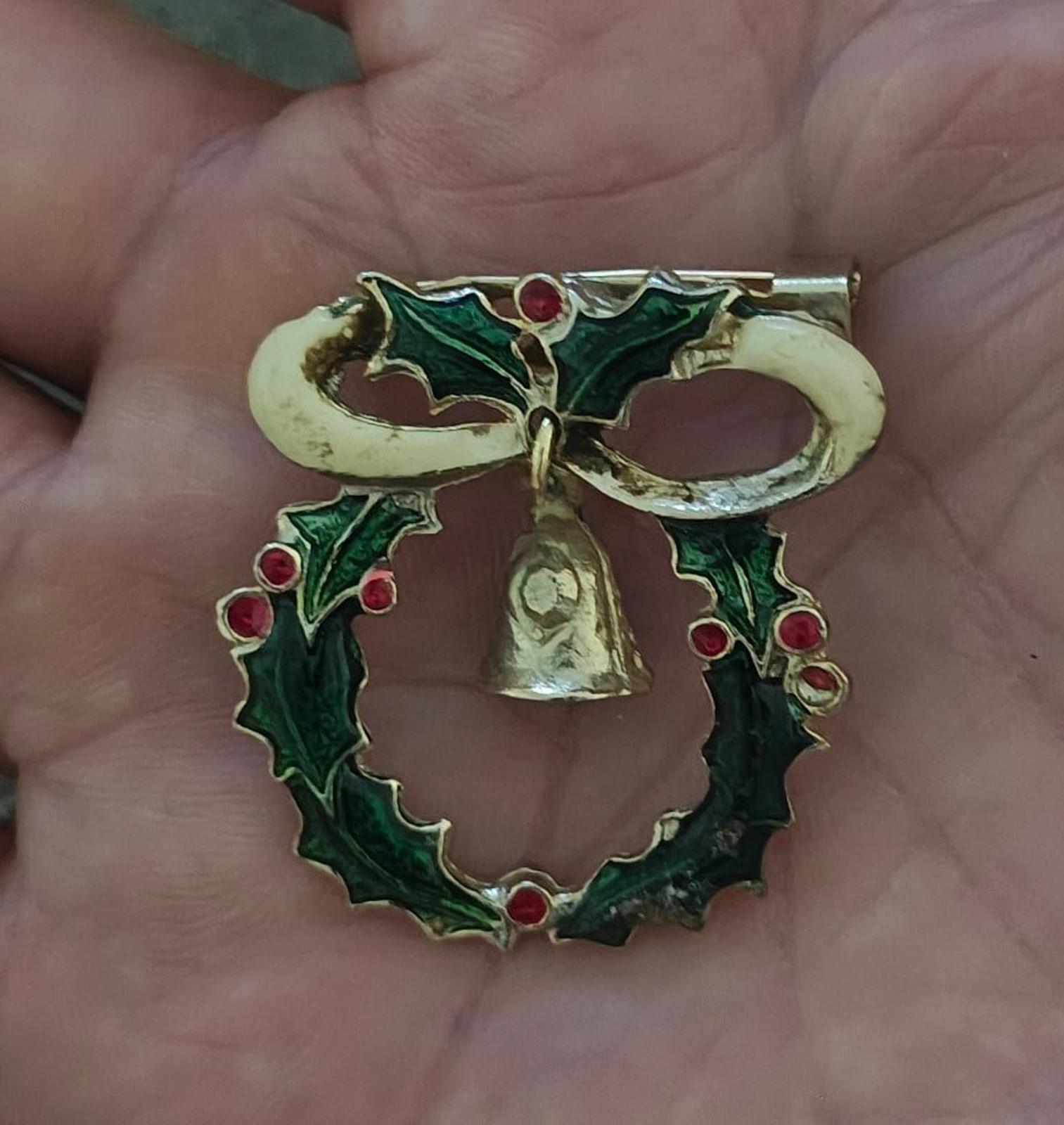 Vintage-style Christmas wreath brooch with green enamel leaves, red berries, and gold bell
