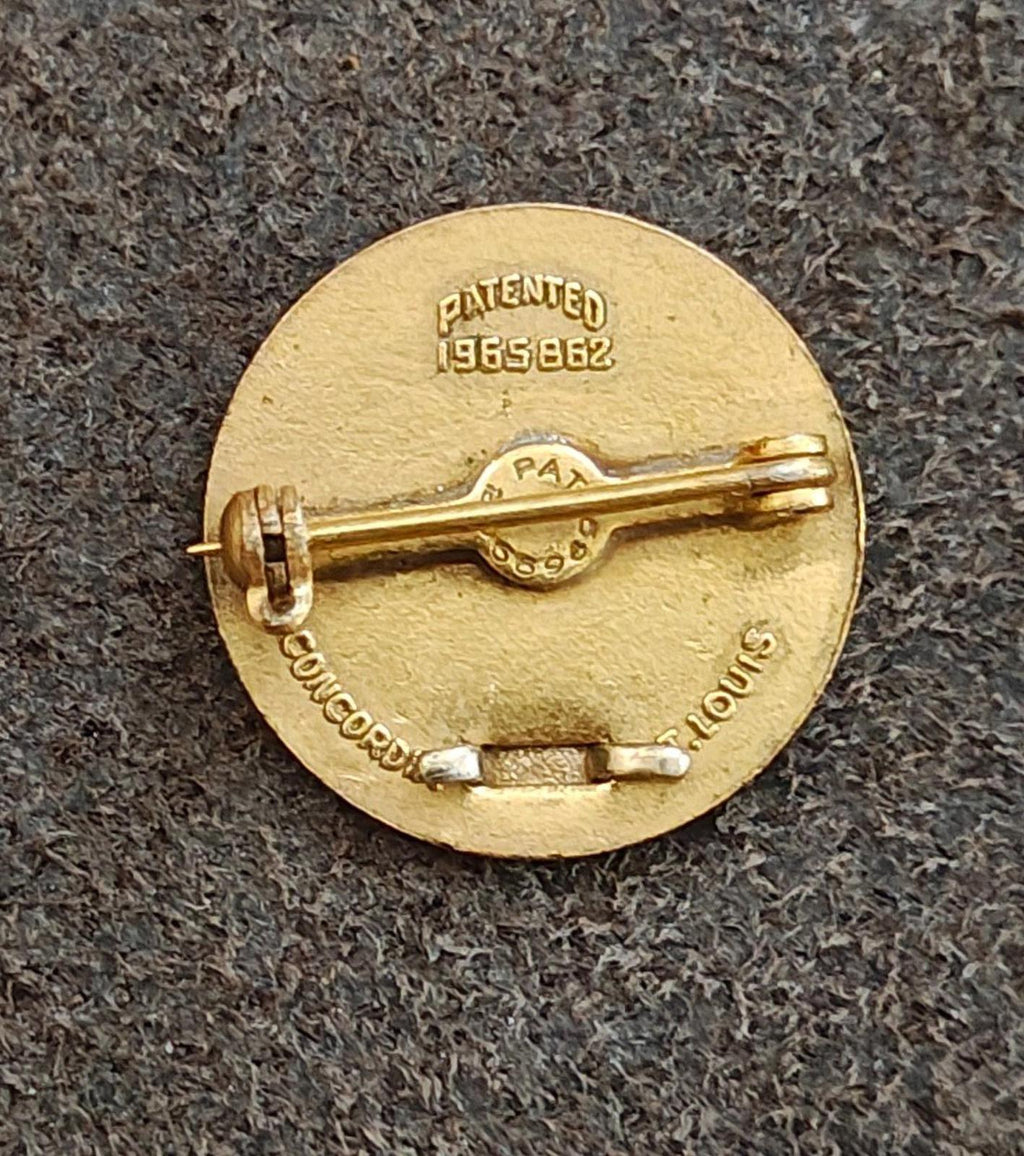 Back side of vintage gold-tone award pin, stamped "PATENTED 1958-62" and clasp hardware