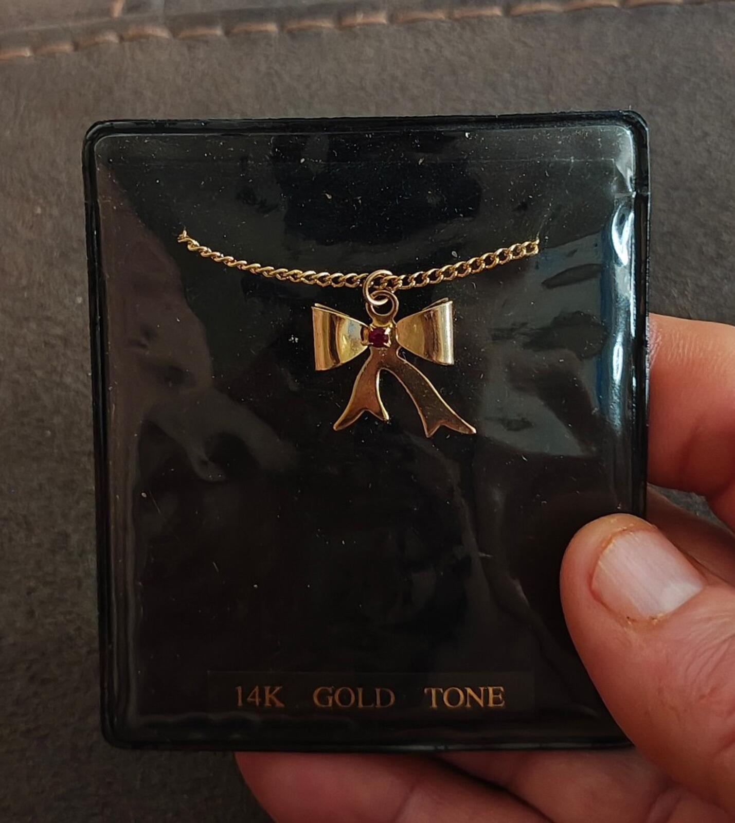 1980s 14k Gold Tone Bow Pendant Necklace With Vibrant Red Stone