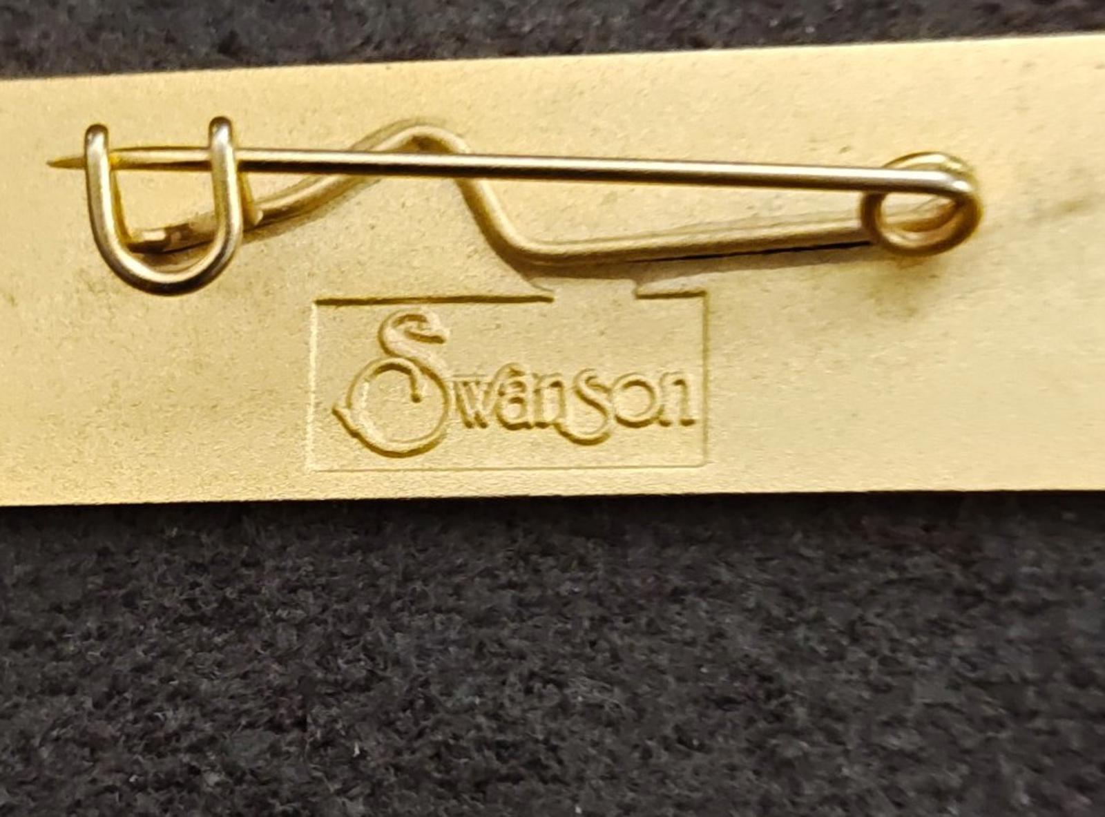 Gold tone brooch pin back with safety pin and Swanson branding