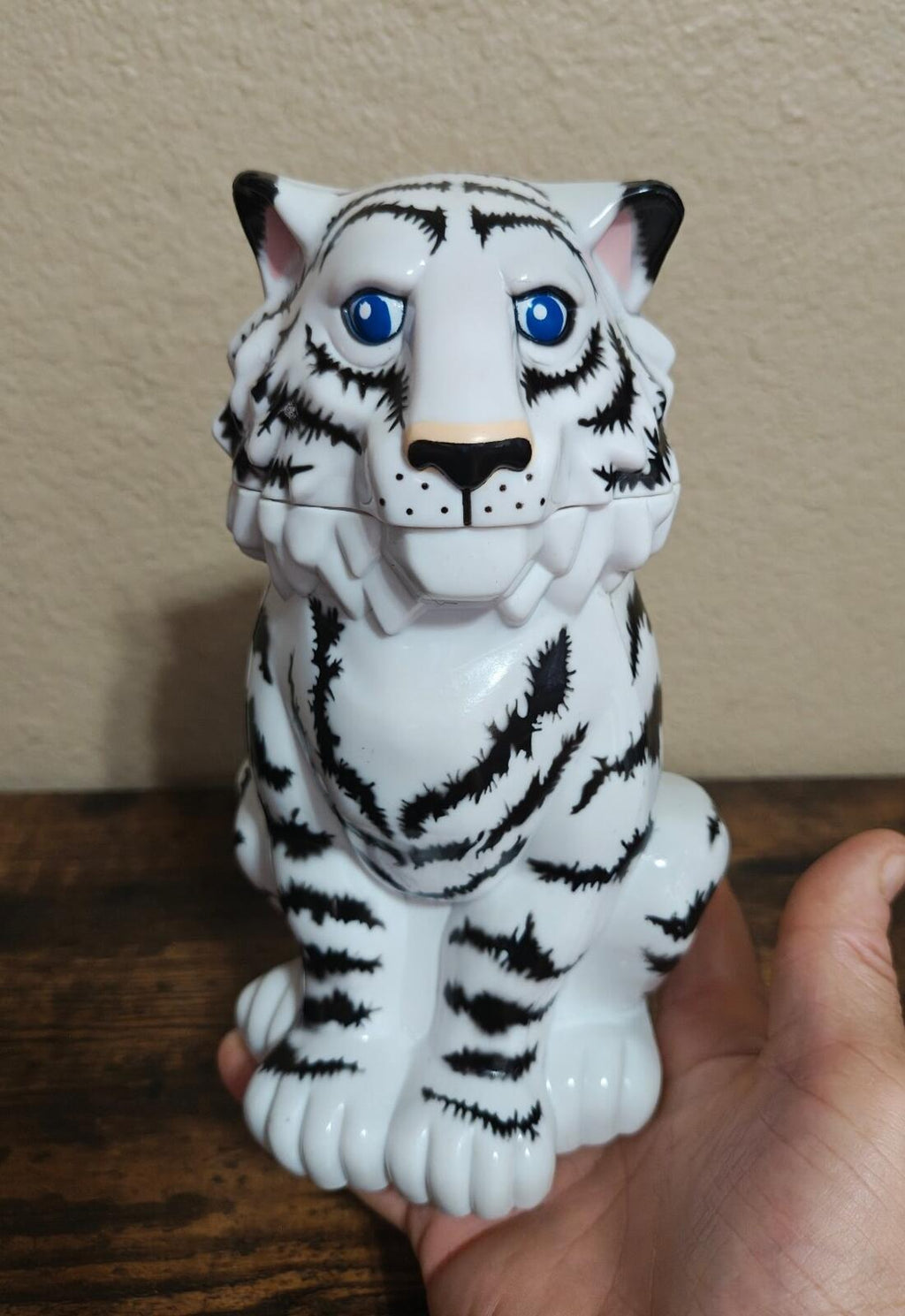 Tiger-shaped ceramic souvenir mug front view, white with black stripes and blue eyes