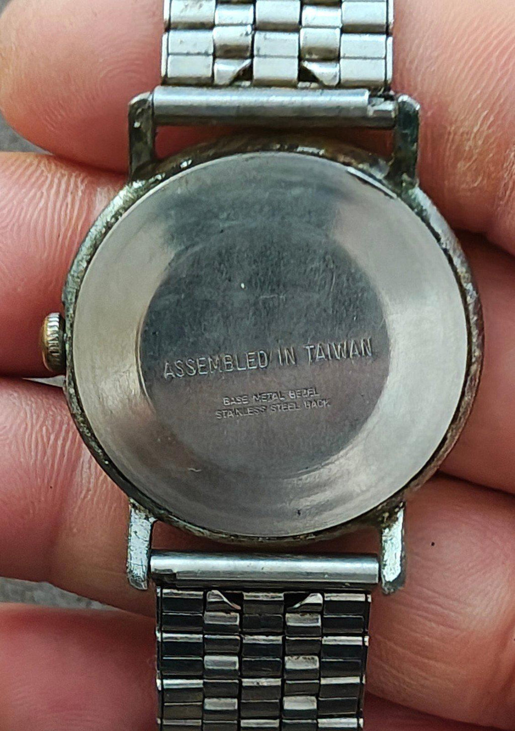 Timex Mercury case back with “ASSEMBLED IN TAIWAN” text and silver metal bracelet