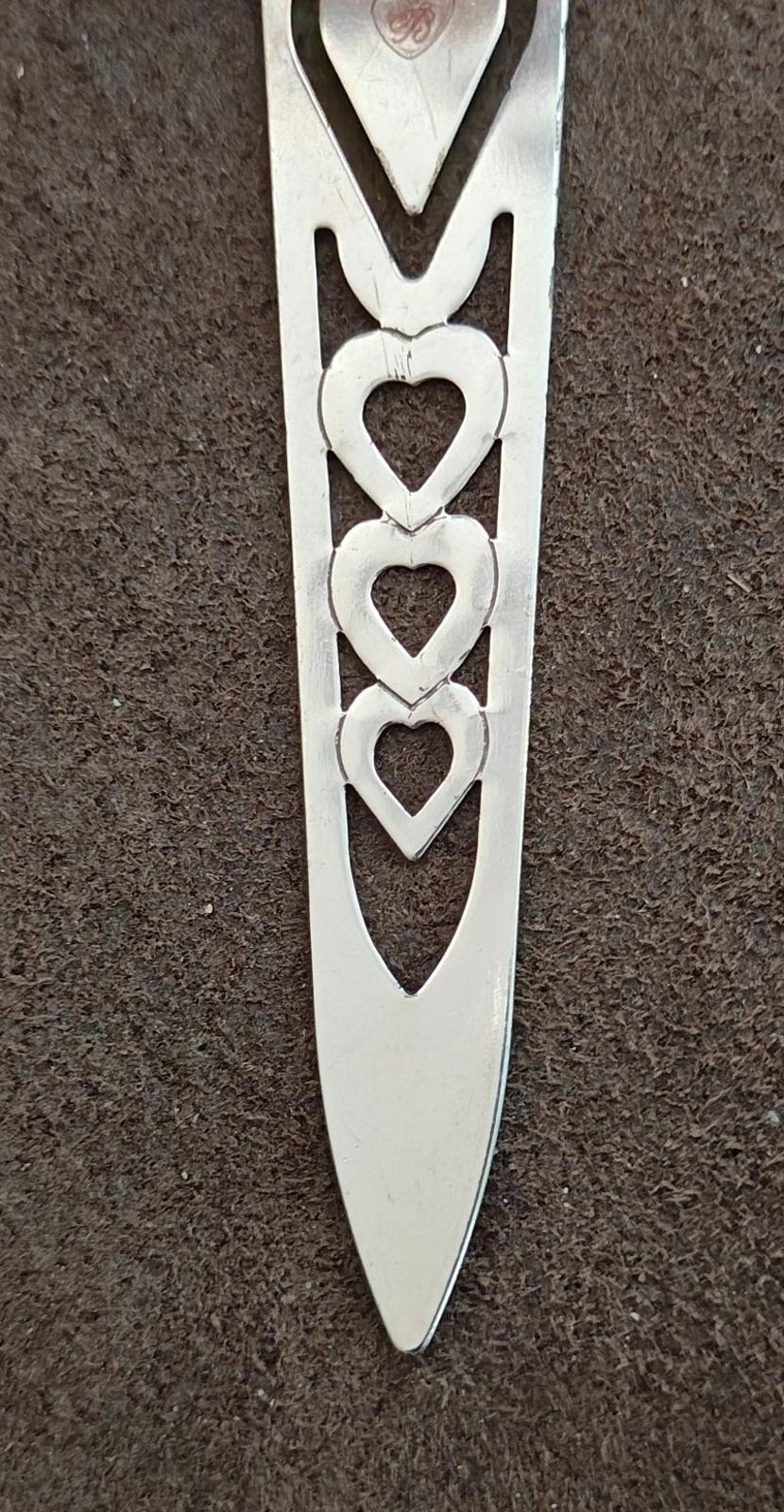 Silver plated letter opener bookmark with stacked heart cutouts and pointed tip