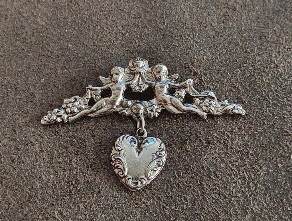 1980s Silver Tone Renaissance Style Cherub Brooch With Dangling Heart Charm