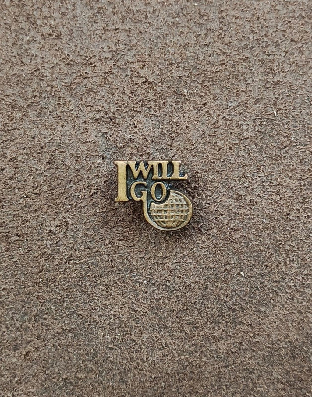 Gold tone "I WILL GO" ministry pin with globe-style emblem, small centered close-up