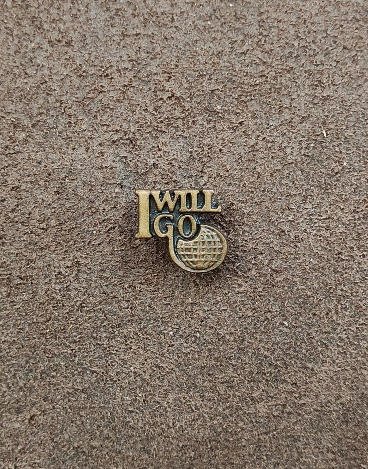 Gold tone "I WILL GO" ministry pin with globe-style emblem, small centered close-up