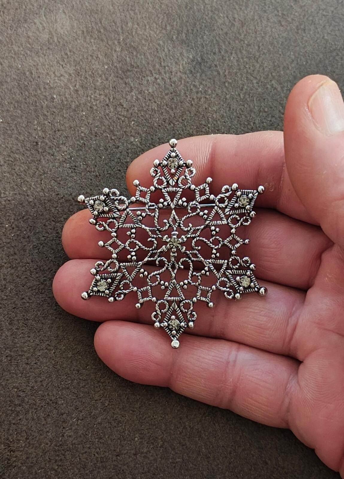 1990s Silver Tone Filigree Snowflake With Clear Rhinestone Accents Brooch.