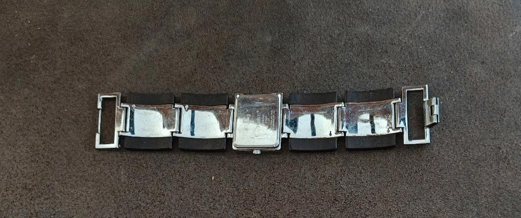 Ladies Fossil watch bracelet profile with silver links and brown wooden band