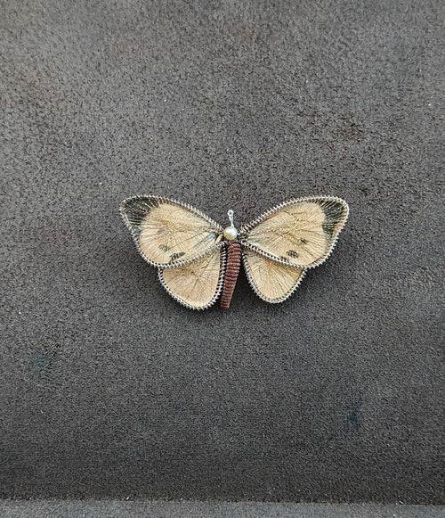 Butterfly brooch pin with gold-tone wire wings and pearl bead center on dark red body