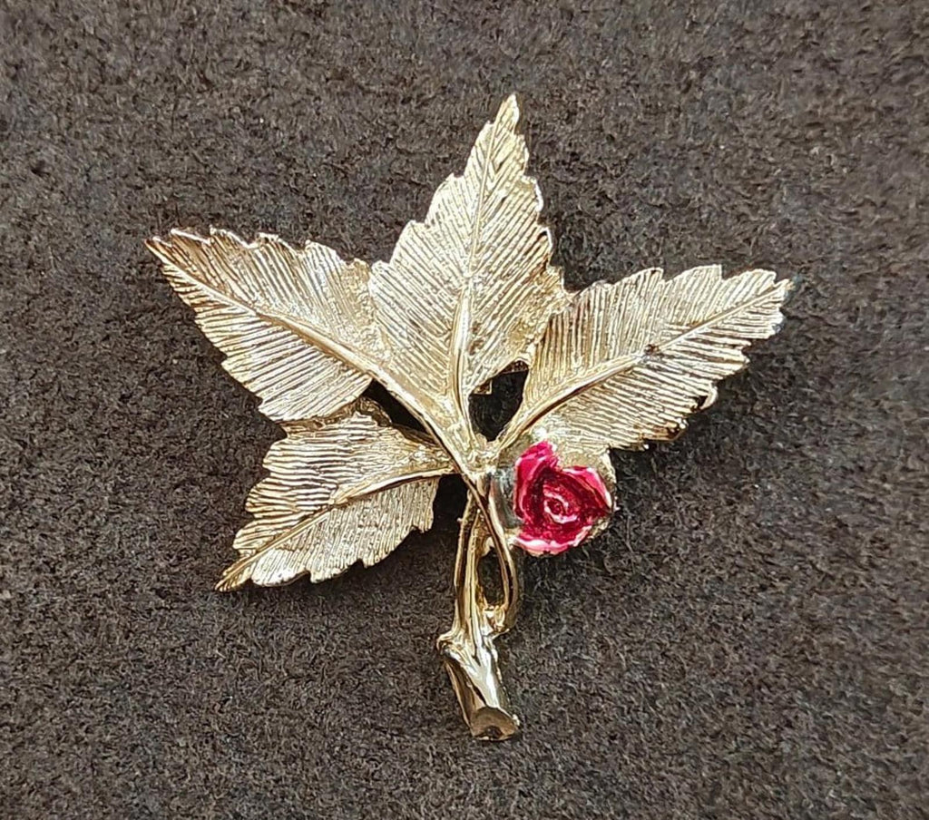 Gold-tone leaf cross pin brooch featuring red rose and Mary medallion