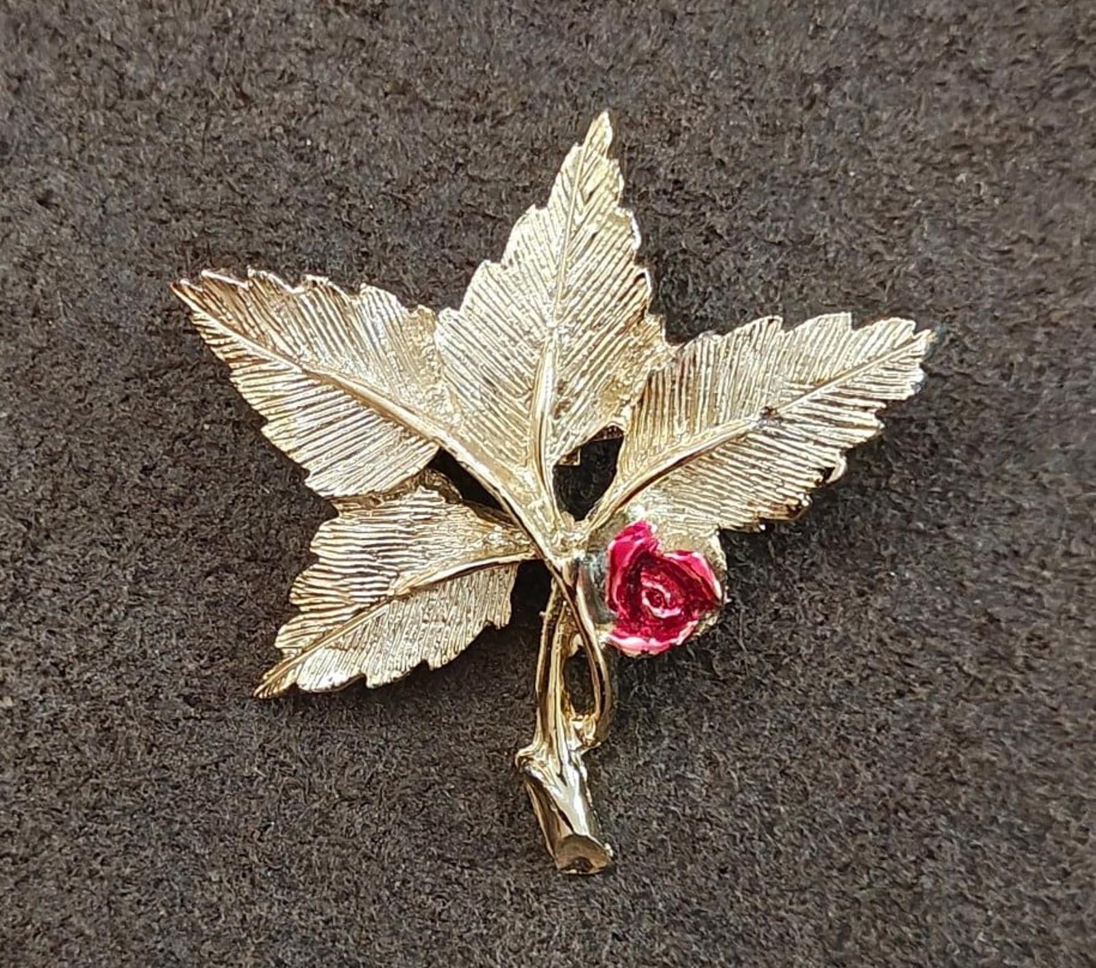 Gold-tone leaf cross pin brooch featuring red rose and Mary medallion