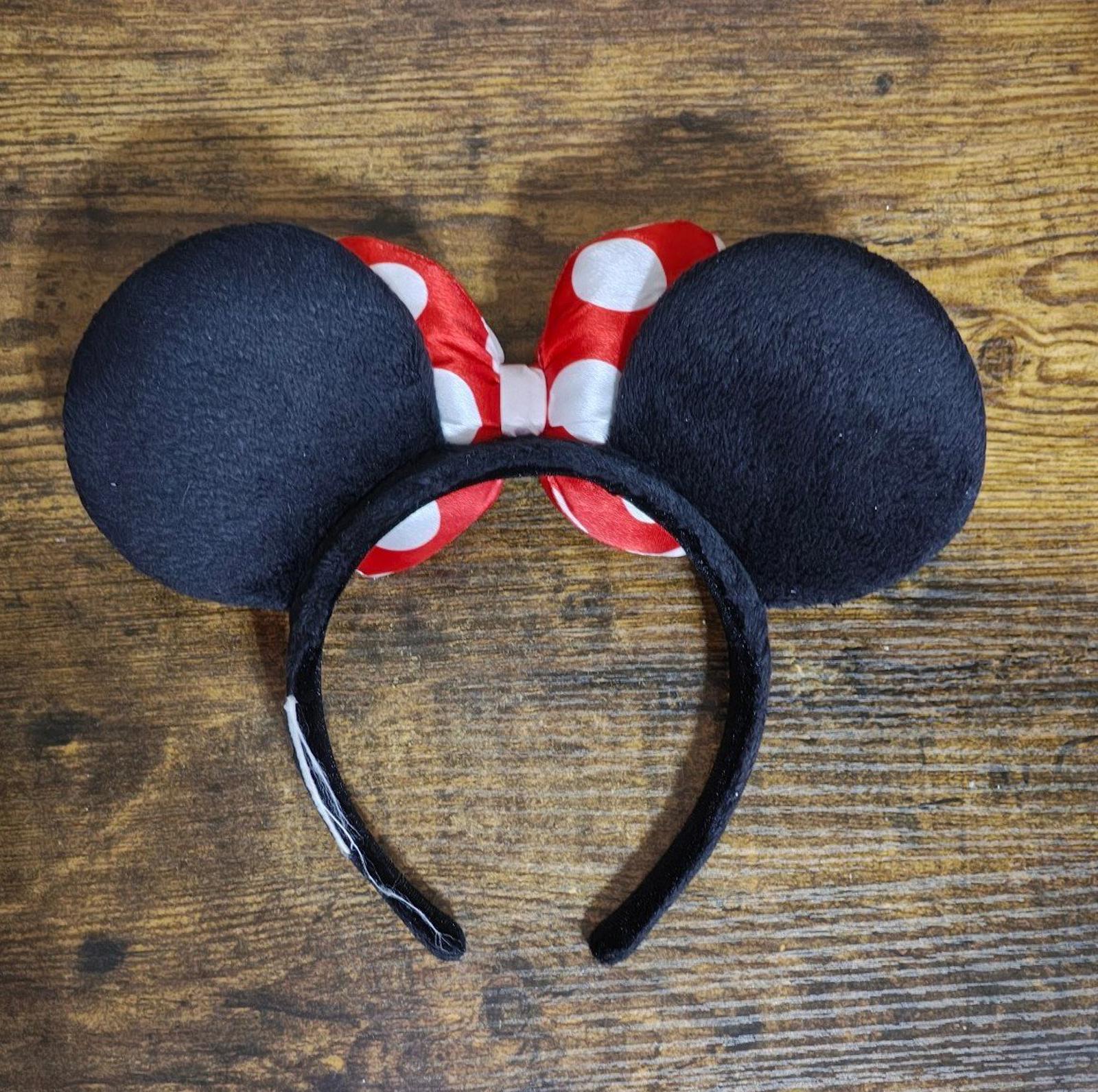 Curved headband with red and white polka-dot bows and wide black fabric ears