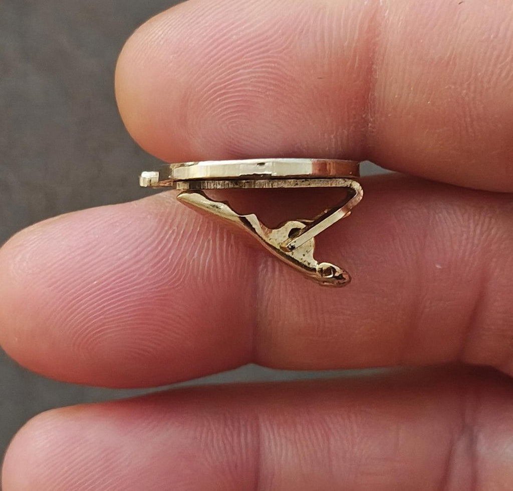 Gold-tone enamel tie clip underside with metal pin and clasp mechanism
