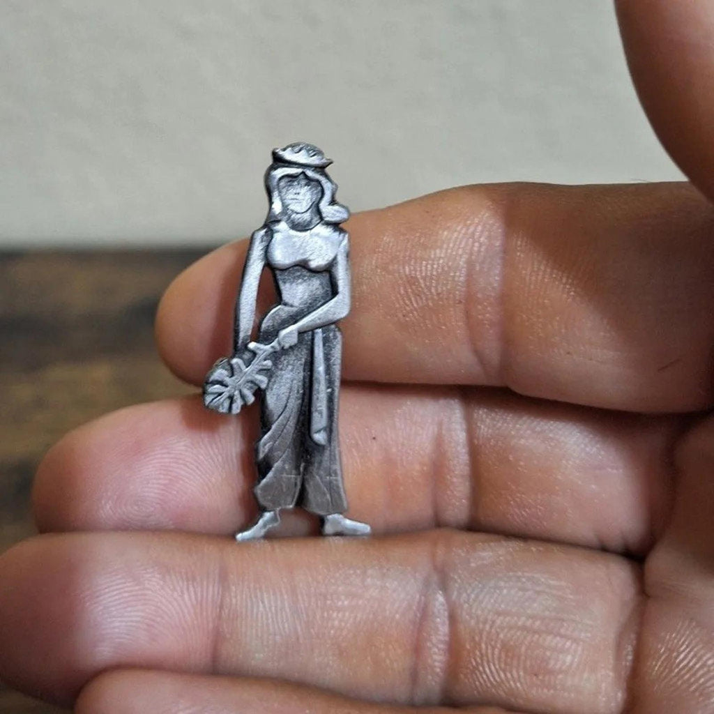 Metzke pewter girl brooch pin, close-up of hat, dress, and floral accent, silver-tone