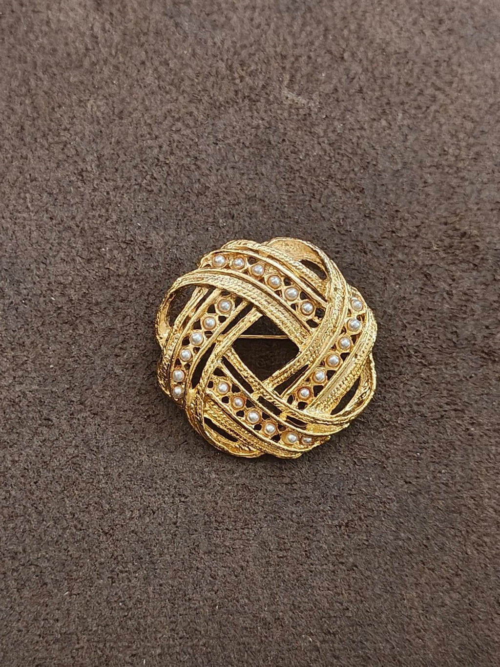 Gold-tone oval brooch with faux pearl accents and lattice-like filigree design